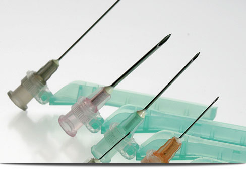 Needles with safety cap